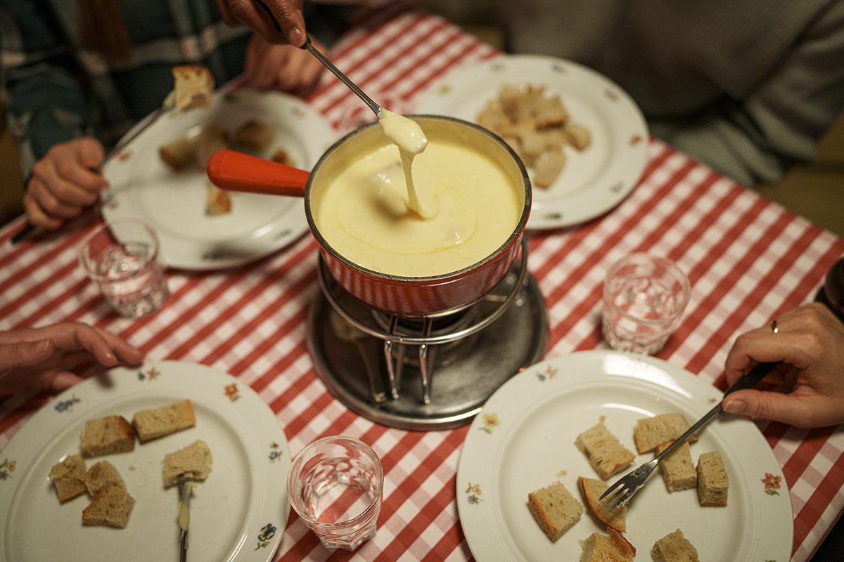 Gruppe geniesst ein Fondue im Restaurant Theodors Stuba in Zermatt.